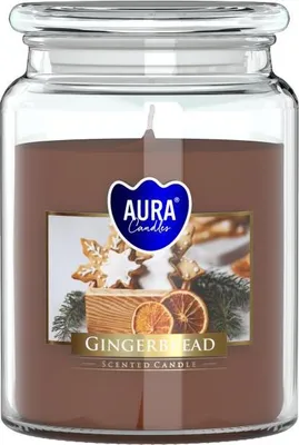 A large scented candle in a glass jar with a lid, featuring a label with gingerbread and orange slices.