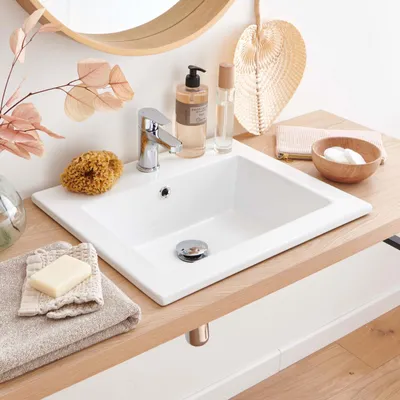 A bathroom sink area with various accessories.