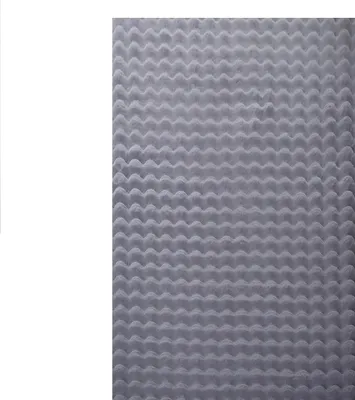 A close-up, top-down view of a gray, textured rug with a wavy pattern.