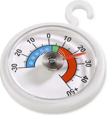 A close-up view of a round thermometer with a white casing and a hook for hanging.