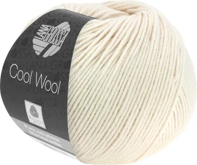 A ball of cream-colored wool yarn with a dark label wrapped around it.