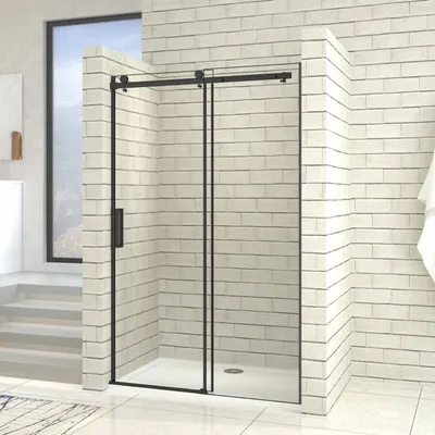 A modern bathroom with a black framed sliding glass shower door.
