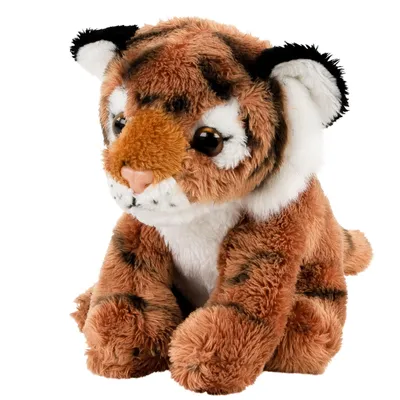 A stuffed toy tiger cub is sitting and facing slightly to the left.