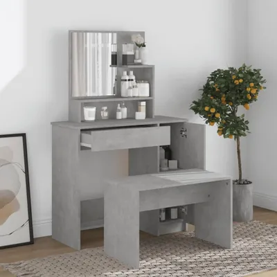 A makeup vanity with a mirror and stool, along with a potted plant, in a room.