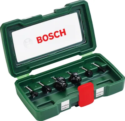 A green Bosch tool case with a clear lid, showing a set of router bits inside.