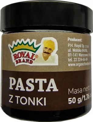 A close-up of a small jar of tonka bean paste.