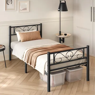 A bedroom scene with a single bed, bedding, and a bedside lamp.