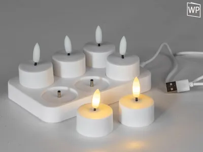 A set of six LED tea lights with a charging station and a USB cable.
