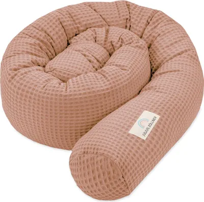 A coiled baby nest/bumper in a waffle knit fabric.