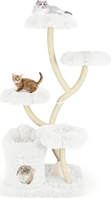 A multi-level cat tree with plush white platforms and a cave, featuring two cats.