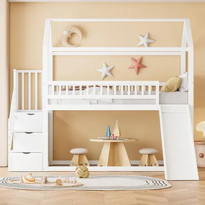 A child's bedroom with a white bunk bed, slide, and stairs with storage drawers. Decorated with stars and a moon.