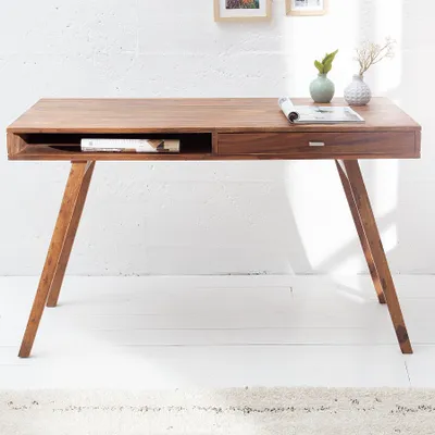 A wooden desk in a bright room.