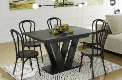 A dining room set with a table and chairs on a rug.