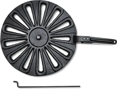 A black cast iron stove grate with a handle and a separate metal poker tool, isolated on a white background.