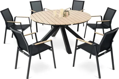 A round wooden dining table with six black chairs around it, set against a white background.