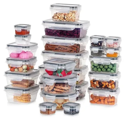 A collection of clear plastic food storage containers with gray lids, filled with various food items, arranged in stacks.