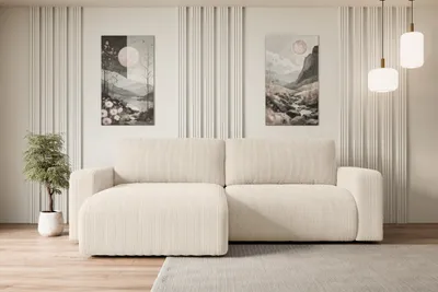 A modern living room with a beige sectional sofa, decorative wall panels, and artwork.