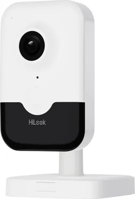 A white and black security camera on a white stand against a white background.