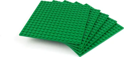 A stack of green LEGO baseplates on a white background.
