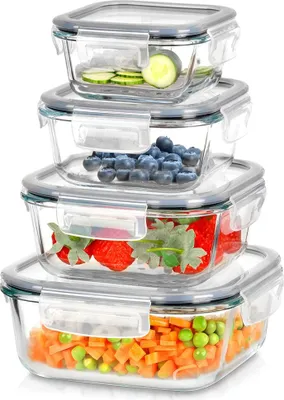 A stack of four glass food storage containers filled with different foods.