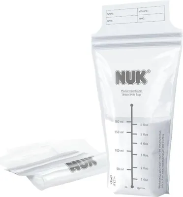 A close-up of NUK breast milk storage bags, with one bag filled with a white powder and several other bags stacked in the foreground.