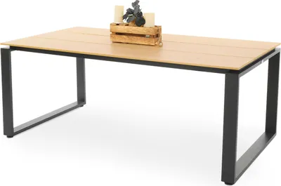 A rectangular dining table with a light wood-look top and black metal legs, set against a white background. A small wooden crate with two candles and decorative greenery sits on the table.