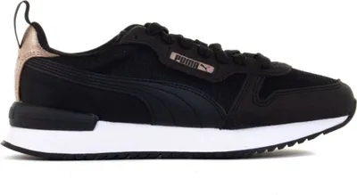 A side view of a black Puma sneaker with white soles and rose gold accents.