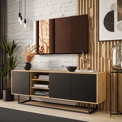 A modern living room with a TV stand, TV, and decor.