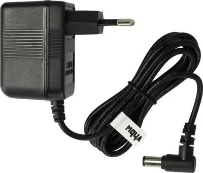 A black power adapter with a European plug and a coiled black cable with a DC barrel connector.