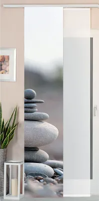 A panel curtain with a stone stacking design is shown hanging in a room.