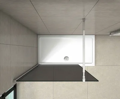 A top-down view of a shower enclosure with a white shower tray and a dark glass panel.