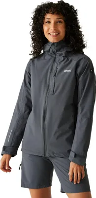 A woman wearing a gray jacket and shorts against a white background.