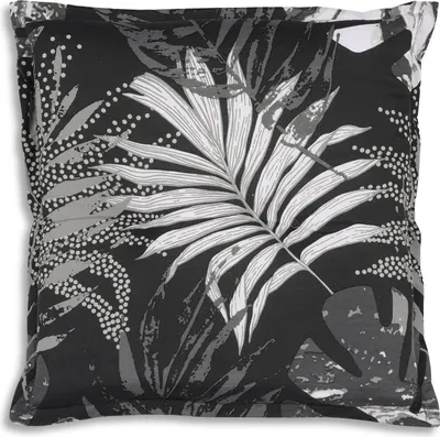 A close-up view of a pillow with a tropical leaf pattern.