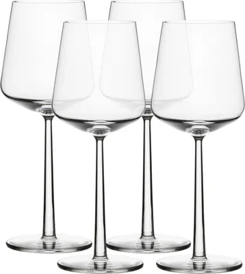 Four clear wine glasses on a white background.