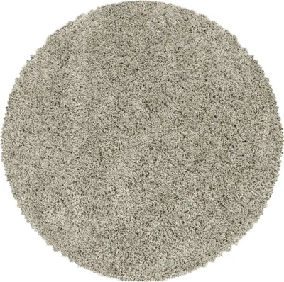 A round, shaggy rug in a neutral gray color is shown from a top-down perspective against a white background.