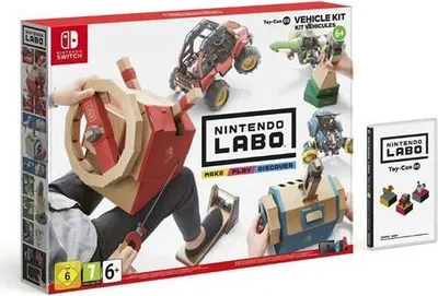 The image shows the packaging of the Nintendo Labo Toy Con 03 Vehicle Kit, with a person interacting with the cardboard creations.