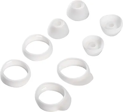 A collection of white silicone ear tips and rings for earbuds, arranged on a white background.