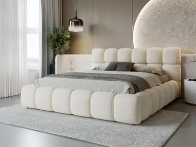 A modern bedroom with a large, upholstered bed as the focal point.