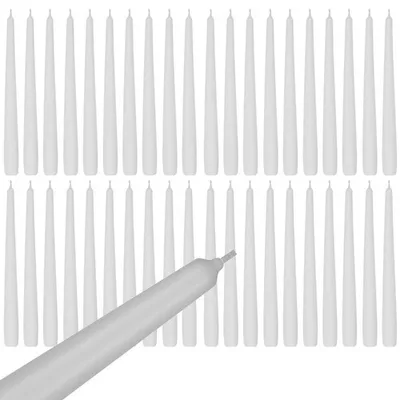 A collection of white taper candles arranged in rows, with one candle in the foreground angled upwards.