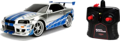 Zdjęcie produktu dla Jada Toys Fast & Furious RC car, 2002 Nissan Skyline GT-R, R34, samochód zdalnie sterowany, funkcja turbo, 2-kanałowy pilot radiowy, funkcja ładowania USB, w zestawie baterie, 1:16, niebieski/srebrny