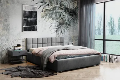 A bedroom scene with a bed, nightstand, and artwork on the wall.