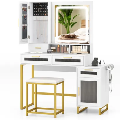 A white vanity set with gold accents, including a mirror with LED lights, drawers, a jewelry cabinet, a stool, and a side cabinet with a hairdryer.