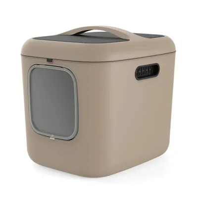 A studio shot of a beige cat litter box with a gray door and a black handle on top.