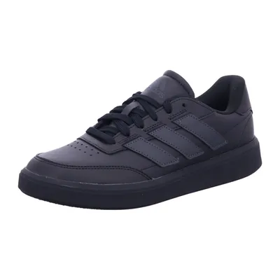 A black Adidas sneaker on a white background.