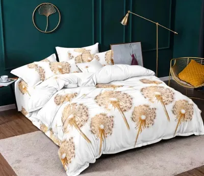 A bedroom scene with a bed dressed in dandelion-themed bedding, a floor lamp, and a chair with a pillow.
