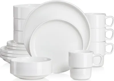 A white ceramic dinnerware set is neatly arranged against a white background.