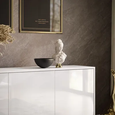 A white high-gloss sideboard with decorative items on top, including a bust and a bowl.