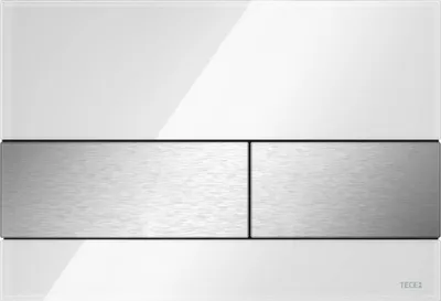 A close-up studio shot of a white and brushed stainless steel toilet flush plate.