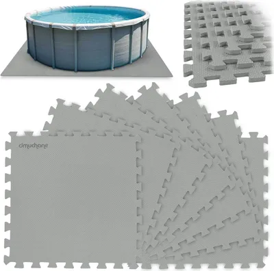 A round above-ground swimming pool is shown on a gray mat, with a pile of interlocking foam puzzle mats in the foreground.