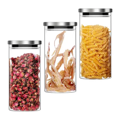 Three glass storage jars with stainless steel lids, each containing different food items.